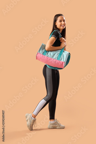 Sporty young woman with bag...