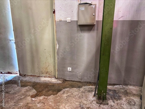 The wall and floor in this area are dirty and damp, requiring urgent repair