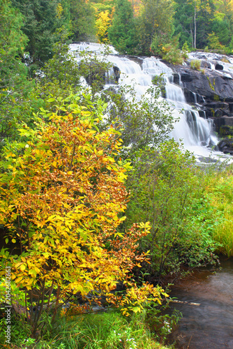Autumn foliage surrounds the cascading waters of Bond Falls in northern Michigan