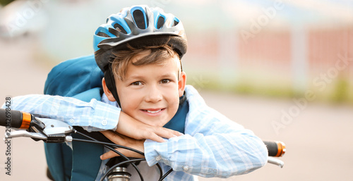 Cute boy riding bicycle out...