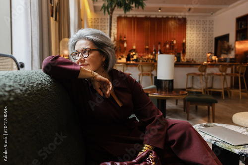 Sophisticated Senior woman relaxing in a luxurious hotel lounge