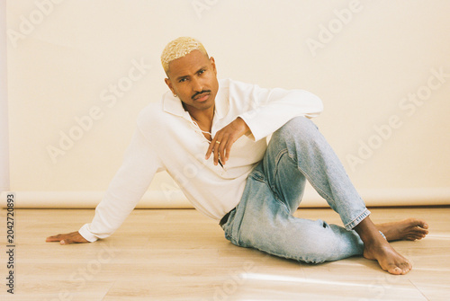 Elegant young man posing on floor