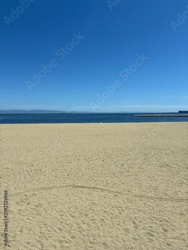 Peaceful Empty Beach with Blue Sky and Sea