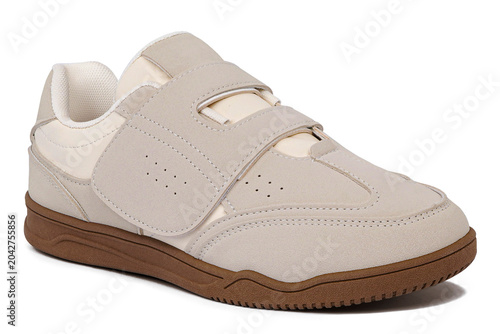 Cream colored casual shoes without laces with brown soles isolated on white background