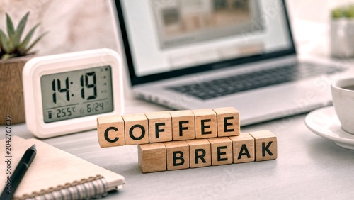 Coffee break message on wooden blocks, office desk workspace with laptop and digital clock, professional remote work environment