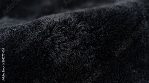 Close-up of soft black fabric texture, fluffy material background