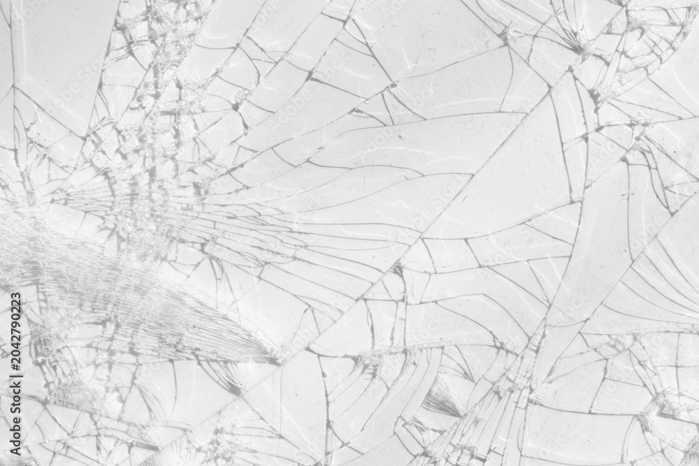Obraz premium Close-up of a shattered glass screen with a spiderweb crack pattern on Transparent background.