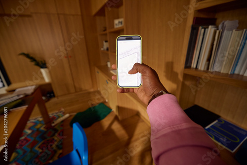 Anonymous person hold a mobile phone with screen turned on