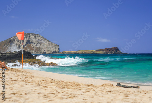 Makapuu Beach with Rabbit Island and a warning flag, windward Oahu, Hawaii