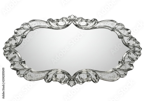 Ornate vintage mirror with intricate design, reflecting light in an elegant setting