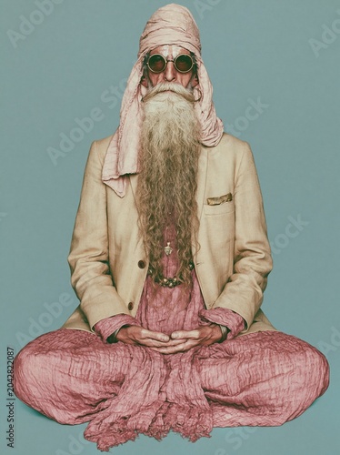 Senior man with long white beard sitting in meditation pose wearing eccentric fashion and sunglasses for wellness advertising, spiritual lifestyle and creative editorial