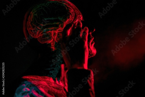 Human brain anatomy and skull profile with hand gesture representing chronic headache or migraine for medical education, pharmaceutical design and wellness research