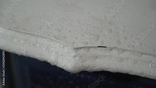 Macro closeup of a man's hand scrubbing and sanitizing a white surface with a white towel. Household tasks. Home chores. Spring cleaning.