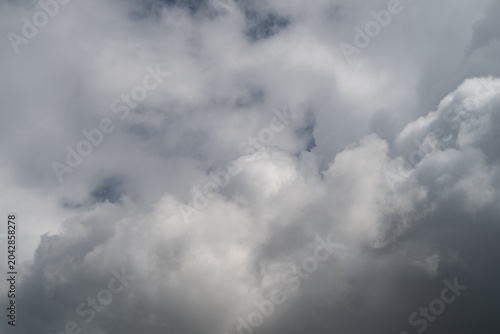Fotografie Thunderous skies with swirling dark clouds foretell coming storm