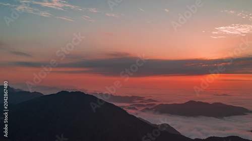 Sunrise Over Mountain Peaks Above a Sea of Clouds