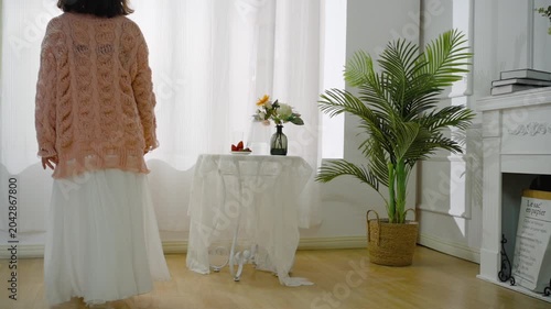 Bright Cozy Living Room Interior with Table, Flowers and Potted Palm