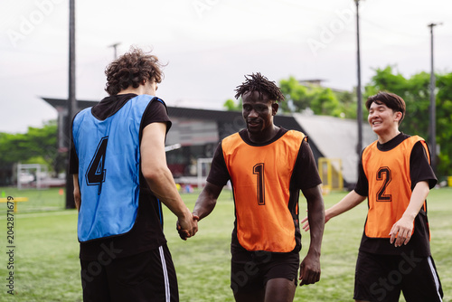 Obraz na plátně Soccer players shaking hands on the field to show sportsmanship and respect after a match
