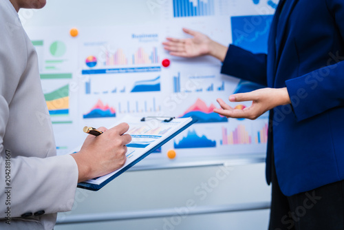 Принти на полотні Experienced Asian woman trains new employee in office work, teaching secretarial duties, document management, assistant manager responsibilities