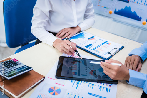 Canvas Print Experienced Asian woman trains new employee in office work, teaching secretarial duties, document management, assistant manager responsibilities