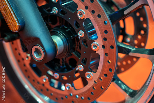 Close-up of a dual disc brake system on a motorcycle front wheel