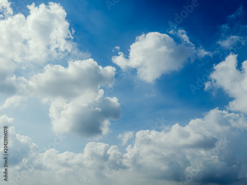 Blue sky with fluffy white clouds on a beautiful sunny day