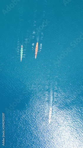 Top Down Aerial View of Rowing Boats Competing in a Race on Turquoise Sea. High quality 4k footage