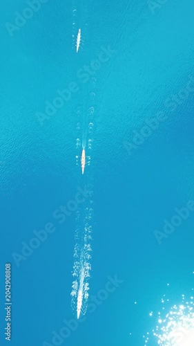 Top Down Aerial View of Rowing Boats Competing in a Race on Turquoise Sea. High quality 4k footage