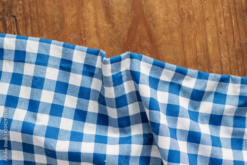 Blue and White Checkerboard Pattern Fabric on a Wooden Surface