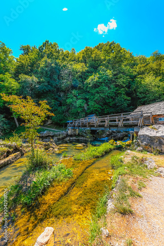 Traditional wooden watermills on the Krupa river waterfalls, a scenic rural landscape near Banja Luka, Bosnia and Herzegovina.