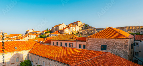 Obraz na płótnie Golden hour panorama of Dubrovnik's historic fortifications and old port at dusk