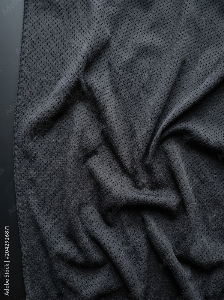 Fototapeta premium Dark-textured athletic mesh fabric details are showcased