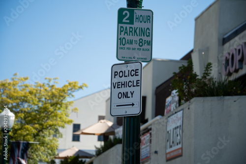 Принти на полотні Street signs indicate parking restrictions and police vehicle access