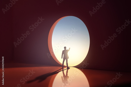 Businessman Standing at Futuristic Circular Aperture in Abstract Room Reaching Toward Light