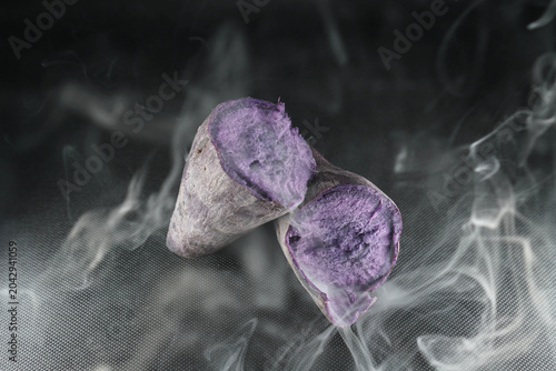 Purple Sweet Potato With Dramatic Smoke on Black Background