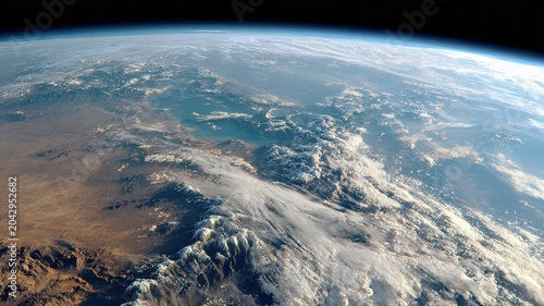 View of Earth from space showing clouds, land forms, and oceans under bright sunlight in a clear atmosphere during daytime hours