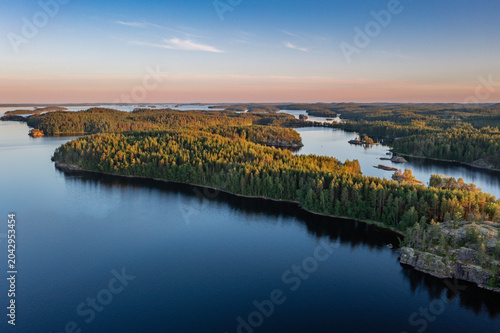 Aerial Sunset View of Saimaa Lake Archipelago and Pine Forests in Finland