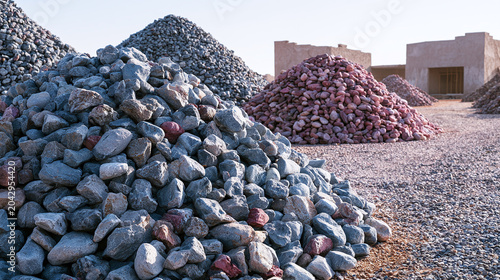 Various sizes of gray stone aggregate ready for construction at a building site