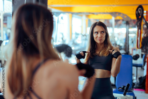 Tableau sur toile Confident Woman Pointing At Herself In Mirror Wearing Gray Outfit
