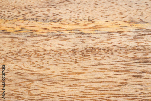 Mango wood texture top view. Kitchen wooden tray background, organic Mangifera indica veneer