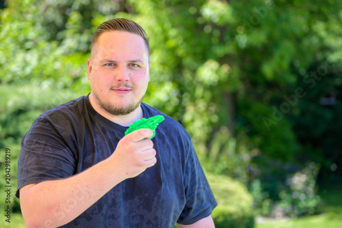 Relaxed Man Holding Water Pistol
