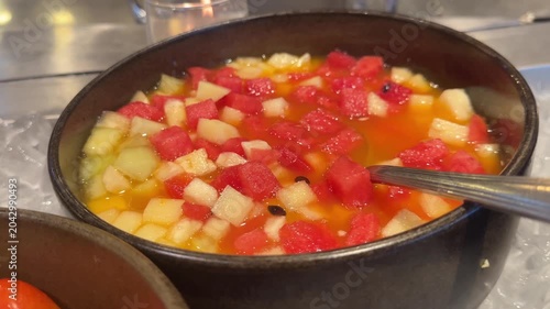 Video of fresh fruit cocktail, cherry tomatoes, cabbage and carrots arranged on a buffet table, showcasing healthy eating and nutrition.
