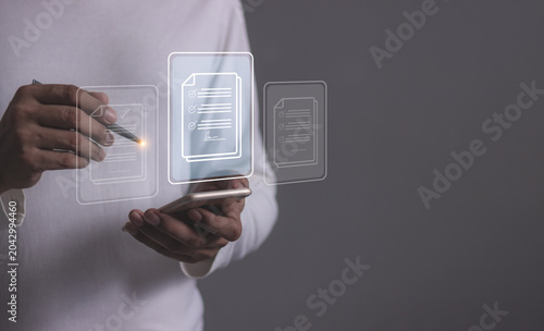 Young man with smartphone mobile hand using a pen touching to sign a Online Business Contract, Electronic signature, Contract signing, Digital documents, Future smart contract