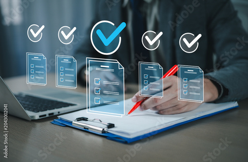 Fotografie Business professionals use laptop computers to manage tasks and monitor work processes, including approval and processing