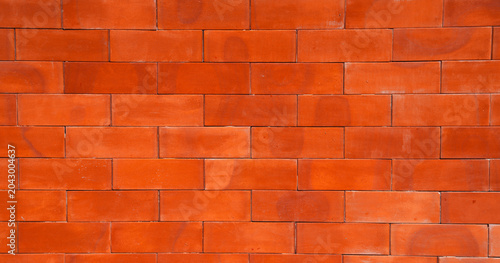 Repeating red brick wall background texture design - found in developed areas like the back of buildings in cities. The file is a loop ready seamless texture file, allowing the picture to be tiled.