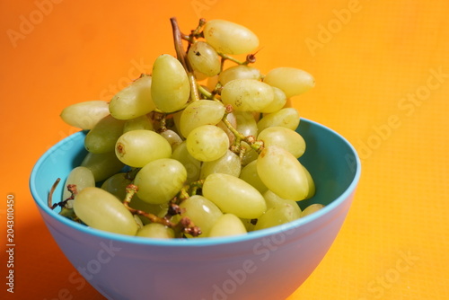 Fresh green grapes hanging in clusters, juicy, nutritious, naturally sweet, and refreshing fruit.