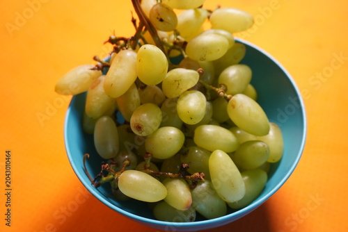 Fresh green grapes hanging in clusters, juicy, nutritious, naturally sweet, and refreshing fruit.