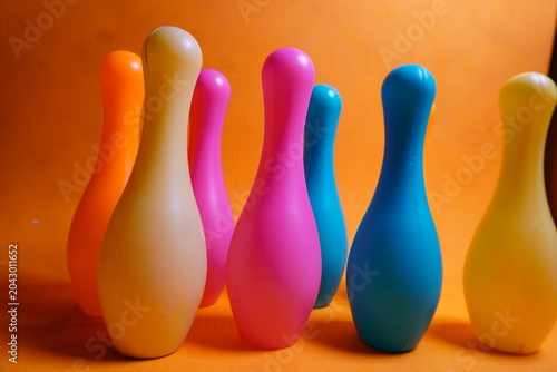 Bright colorful plastic bowling pin toys for children, promoting indoor fun, coordination skills, and playful learning activities.