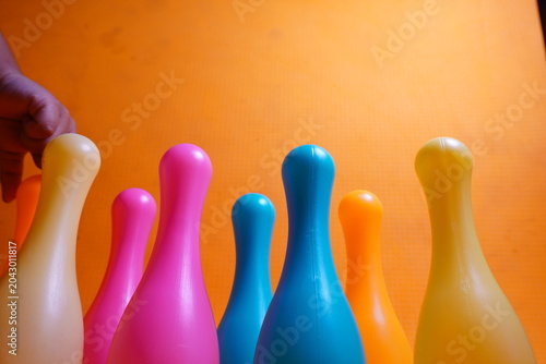 Bright colorful plastic bowling pin toys for children, promoting indoor fun, coordination skills, and playful learning activities.