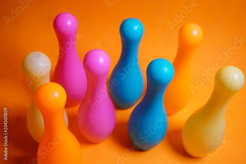 Bright colorful plastic bowling pin toys for children, promoting indoor fun, coordination skills, and playful learning activities.