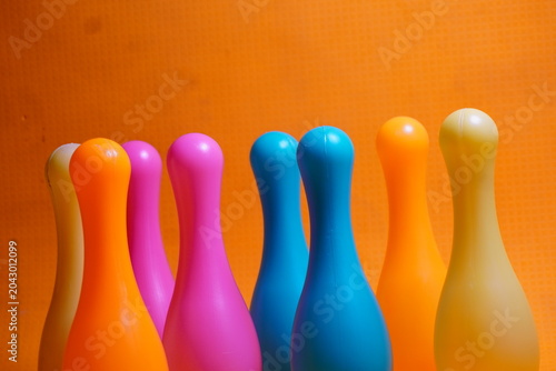 Bright colorful plastic bowling pin toys for children, promoting indoor fun, coordination skills, and playful learning activities.